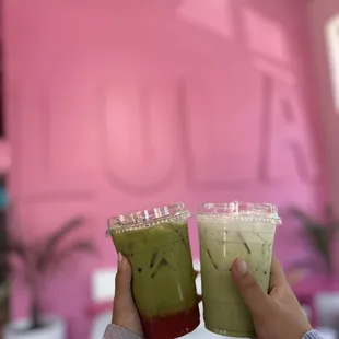 two people holding cups of coffee