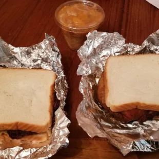 two sandwiches wrapped in foil