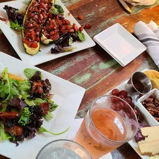 (Top left ) zucchini bruschetta, (front left) devil&apos;s on horseback,  (right) cheese board