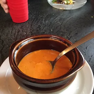 a bowl of soup with a spoon in it