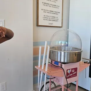 a pink cart with a large glass dome