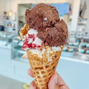 Double scoop with Chocolate Orea and Raspberry Cheesecake  on a brown butter waffle cone