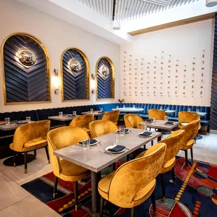 a dining room with yellow chairs