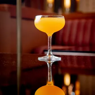 a glass of orange juice on a table