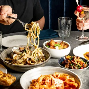 a man eating pasta with a fork