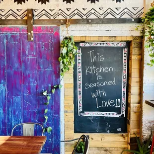 a table and chairs in front of a chalkboard