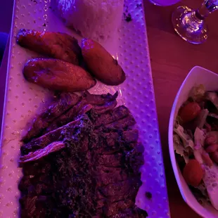 a plate of steak, rice, and vegetables