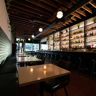 a dimly lit bar with a lot of bottles on the shelves