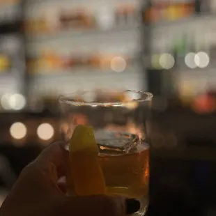 a person holding a glass of alcohol