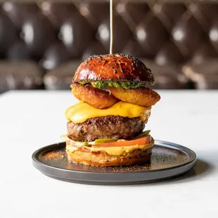 a burger on a plate with a toothpick sticking out of it