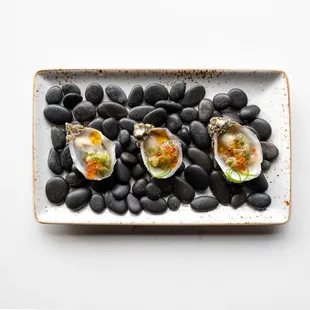 a plate of oysters and black beans
