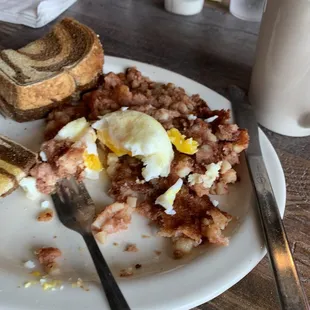 Corned beef hash with a poached egg, rye toast and homemade strawberry jam.