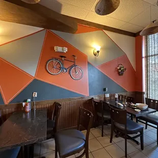 a dining room with a bicycle on the wall