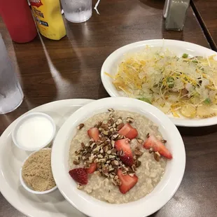 a bowl of oatmeal and a plate of strawberries