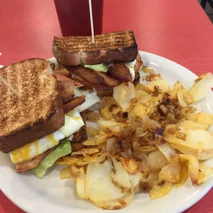 Breakfast Club Sandwich with home fries on the side.