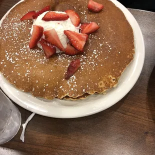 a pancake with strawberries and whipped cream
