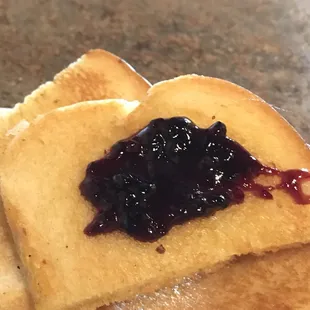 Thick sliced sourdough with blackberry jam is the bomb