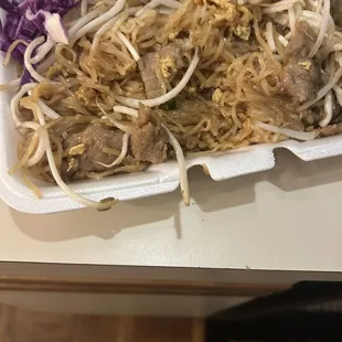 Raman noodles with a touch of beef and a bunch of bean sprouts and cabbage.