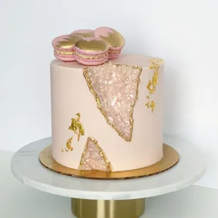 a pink and gold cake