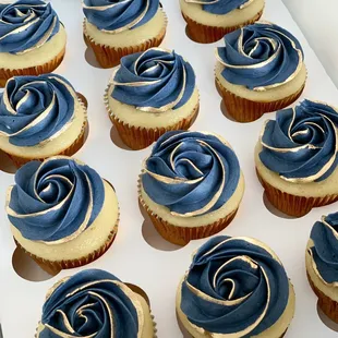 a dozen cupcakes with blue frosting