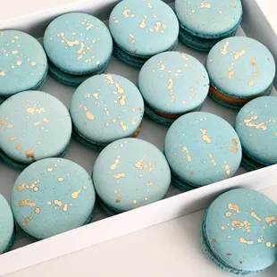 a box of blue macarons