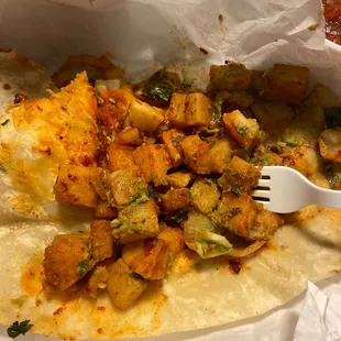 Potato burrito with some guacamole onions and cilantro. Not an ounce of carne asada!