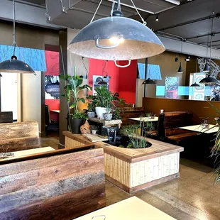 Dining Area with Water Feature and Repurposed Woks as Lights