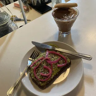 Tiramisu, latte and avocado toast with pickled onion.
