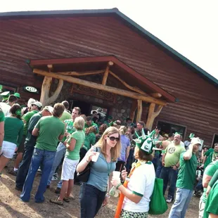 a crowd of people wearing green
