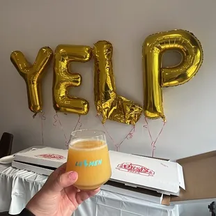 a person holding a glass of beer