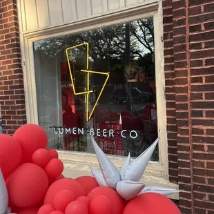 red balloons in front of a window