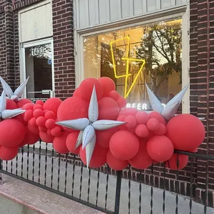 a row of balloons attached to a fence