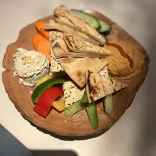 Dip Duo- roasted red pepper hummus, feta spread, veggies, naan bread, &amp; crackers.