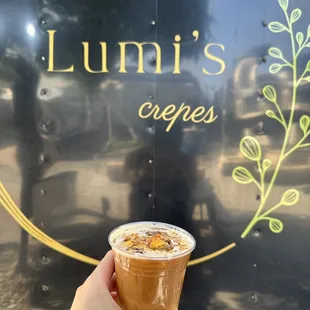 a hand holding a cup of coffee