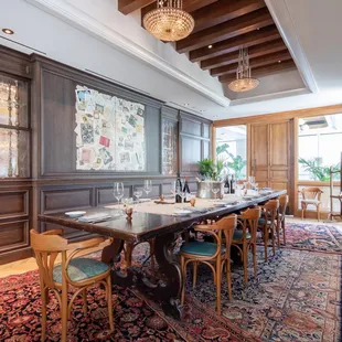 a dining room with wood paneled walls