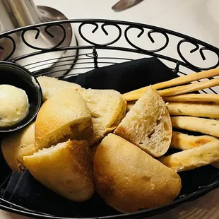a basket of breadsticks and butter