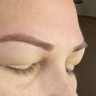 Close-up of right/lower brow after removal: bottom of stencil was aligned just below natural brow, making lower.