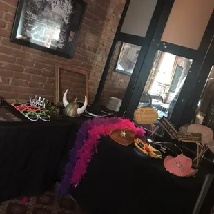 Assorted props include a variety of hats, oversized glasses, colorful boas, &amp; more!