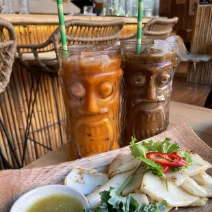 Muk Ka Dong Yang (grilled cuttlefish) up front. Thai Iced Tea with Milk and Thai Iced Coffee with Milk in the back.