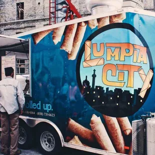 a man standing in front of a food truck