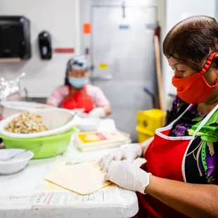  a woman in a kitchen preparing food