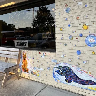 a bench and a mural