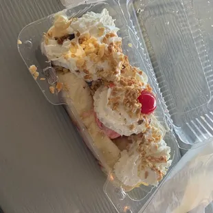 a banana split in a plastic container
