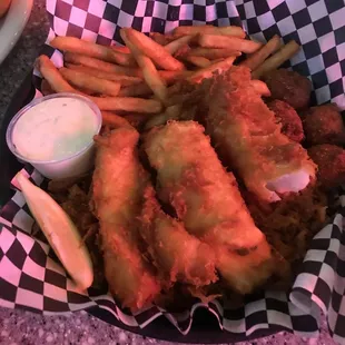 a basket of fried fish and fries