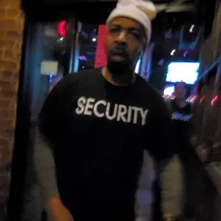 a man in a security t - shirt