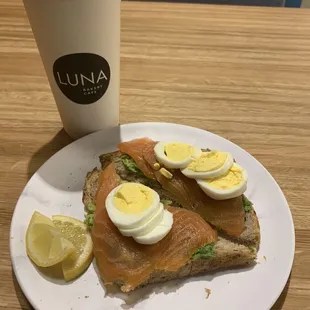 Avocado toast with salmon and hard boiled eggs.