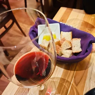 a glass of red wine and bread