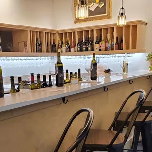 a row of wine bottles on a bar