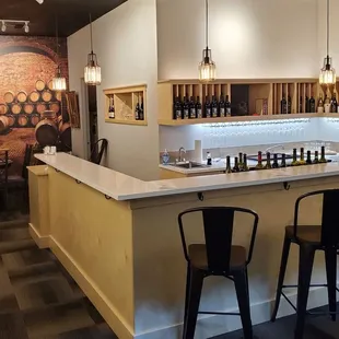 a bar with wine bottles on the wall