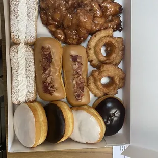 Apple fritters, bismarks, lady fingers cake donuts.